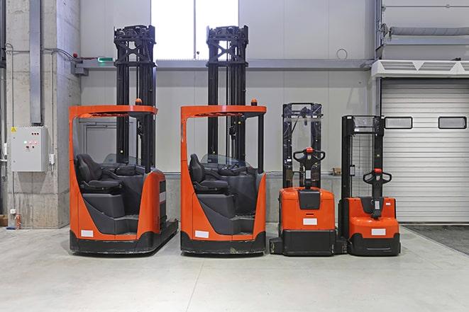 compact forklifts maneuvering in tight warehouse space